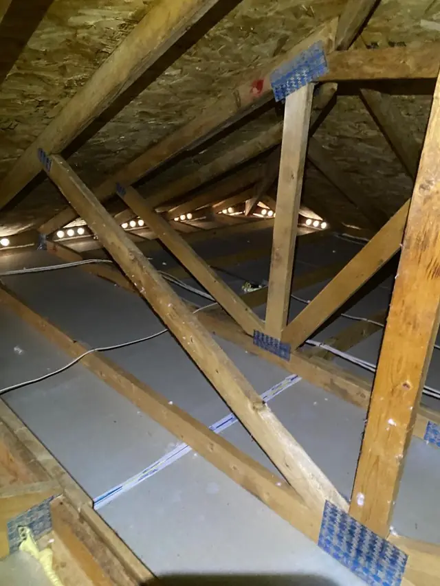 Cleared attic with the ceiling exposed, prepared for insulation