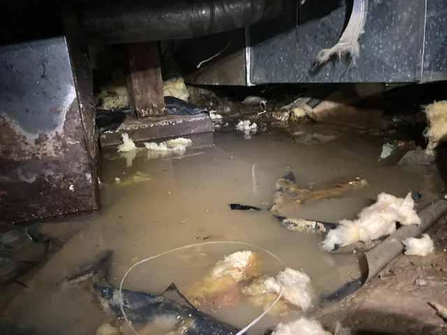 Flooded crawl space before drainage and pumping