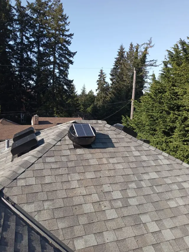Solar attic fan venting a hip roof