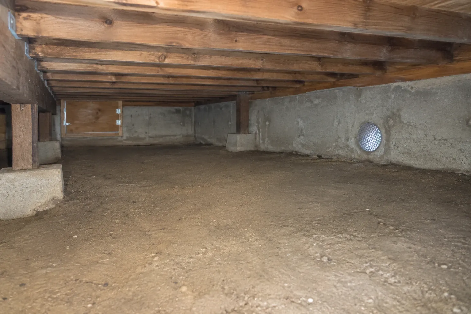After: Clean crawl space with a screened foundation vent.