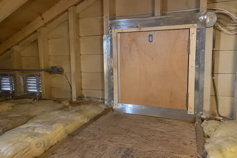 Attic hatch sealed against rodents, after: Hatch frame sealed with steel mesh and sheet-metal flashing, insulation refitted.