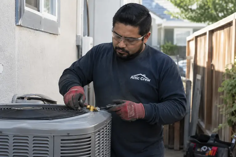 Checking an outdoor AC condenser after installation.