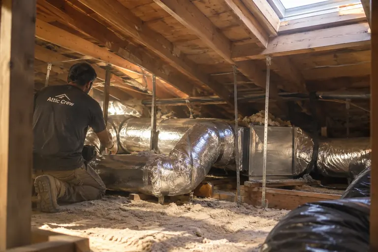 Installing new duct runs to an attic air handler.
