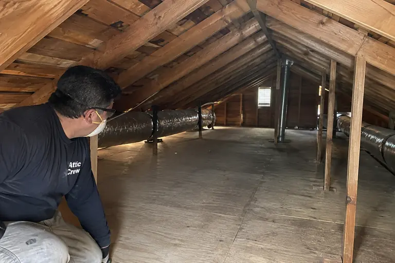A cleared, vacuumed attic ready for new insulation.