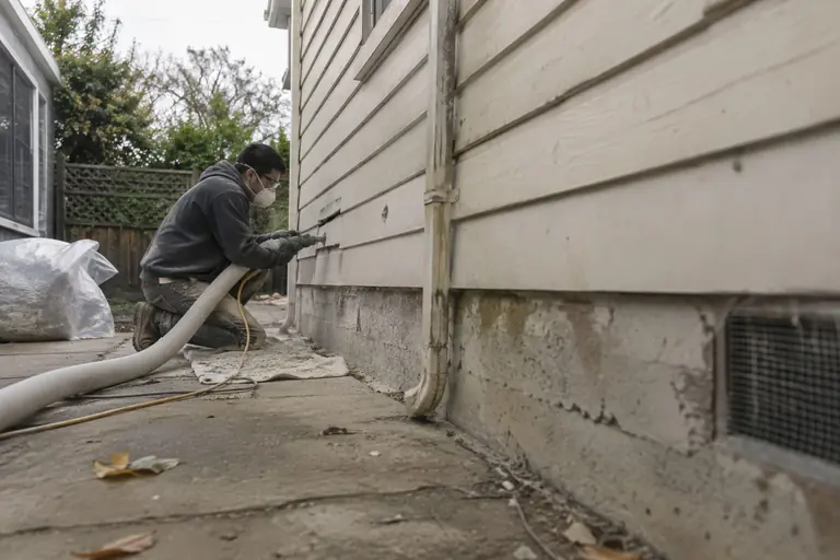 Insulating an exterior wall from outside, through small drilled holes.